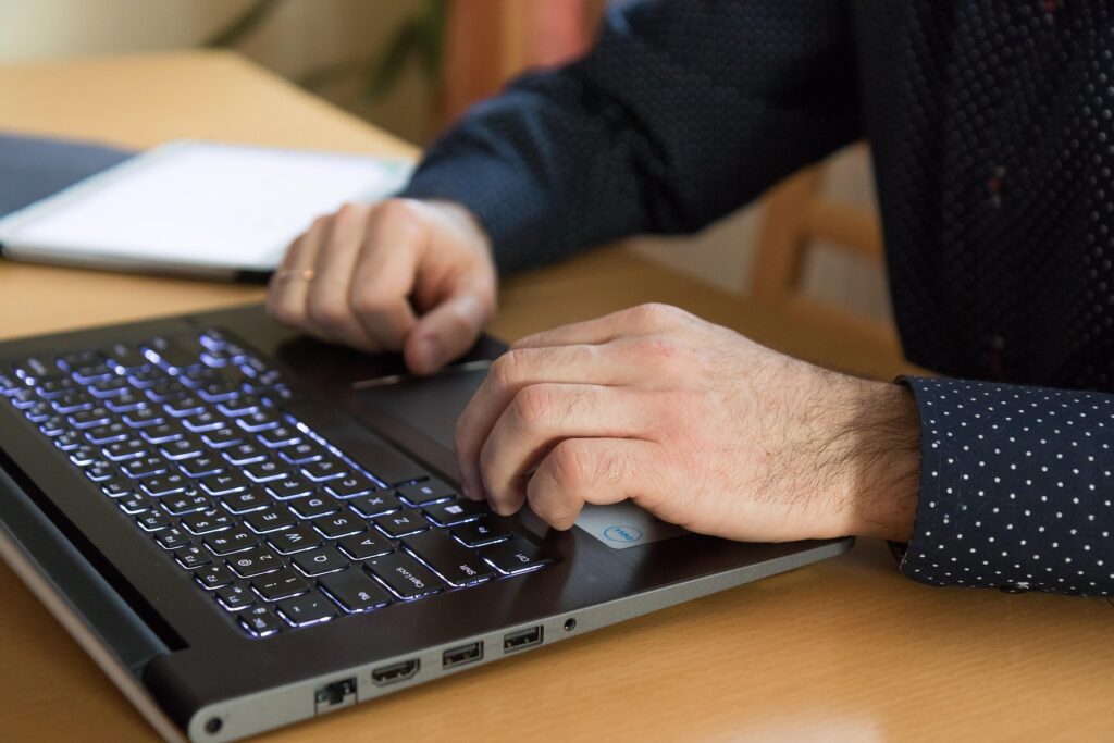 Person working on laptop with financial data representing online income opportunities